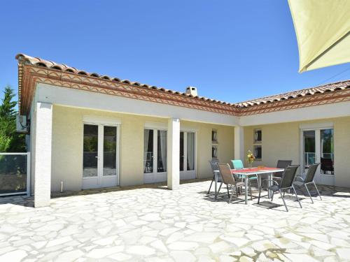 a patio with a table and chairs on it at Luxurious Villa in Oupia with Private Swimming Pool in Oupia