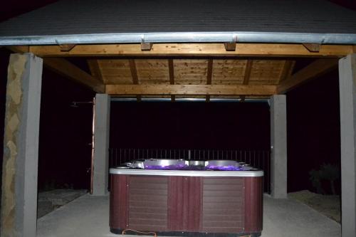 a garage with a hot tub under a roof at Condado de San Martín in Boltaña