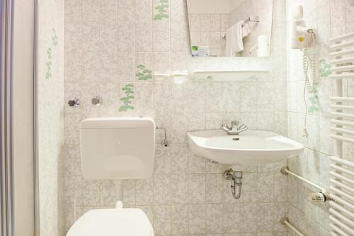 a bathroom with a toilet and a sink at Hotel Hannover Airport by Premiere Classe in Hannover