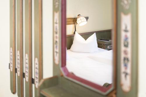 a mirror reflection of a bed with a white pillow at Hotel Hannover Airport by Premiere Classe in Hannover