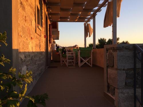 a balcony of a house with a table and chairs at Heliades Maisonettes in Mithymna