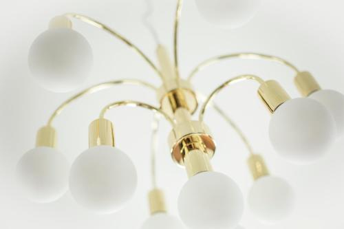 a chandelier with five white lights on it at Hotell Boras, BW Signature Collection in Borås