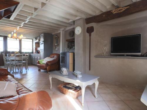 a living room with a couch and a table at Beautiful Cottage in Malempre with Fenced Garden in Manhay