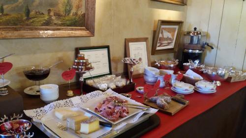 a table with a red table cloth with food on it at Hôtel Saint-Georges in Megève