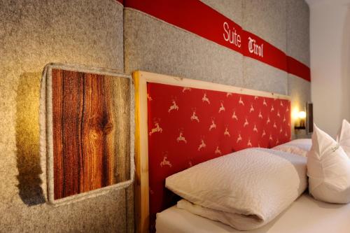 a bedroom with a bed with a sign on the wall at Landhotel zum Bad in Krün