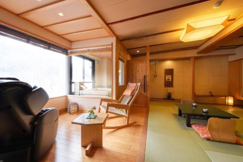 a living room with a ping pong table and a couch at Kansyokan in Mogami