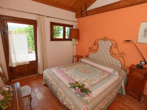 a bedroom with a bed and a window at Detached house in Cagli with swimming pool and garden in Acqualagna