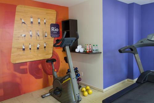 a fitness room with a gym with a treadmill at Rio Hotel by Bourbon Curitiba in Curitiba