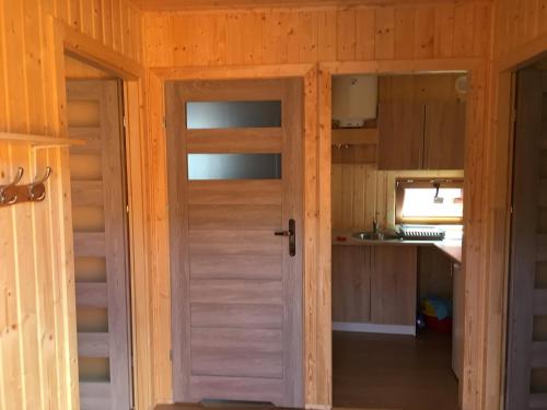 a room with a door and a kitchen at Ośrodek Słonecznik in Hel