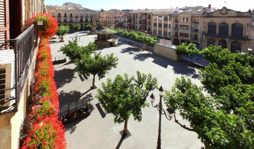 a street scene with trees and a building at Hostal Arotza in Tafalla