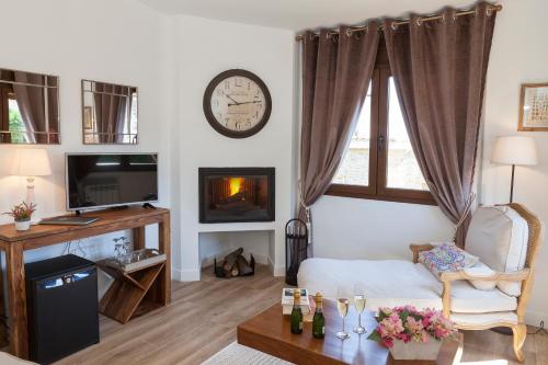 a living room with a clock on the wall at El Racó de Madremanya - Adults only in Madremanya