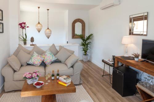 a living room with a couch and a table at El Racó de Madremanya - Adults only in Madremanya