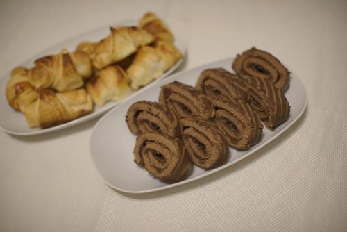 two plates of pastries and croissants on a table at Yoruk Stone House in Nevsehir