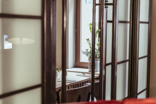 a room with a table and a window and a mirror at alexxanders Hotel & Boardinghouse, Restaurant in Chemnitz