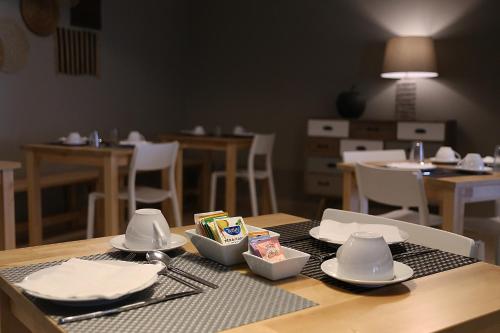 a table with plates and dishes on top of it at Cosy Sintra in Sintra