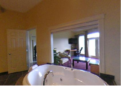 a large bathroom with a tub and a living room at Ciliegia Villa in Osoyoos