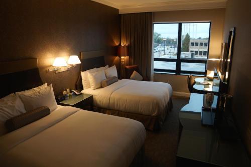 a hotel room with two beds and a window at La Banque Hotel in Homewood