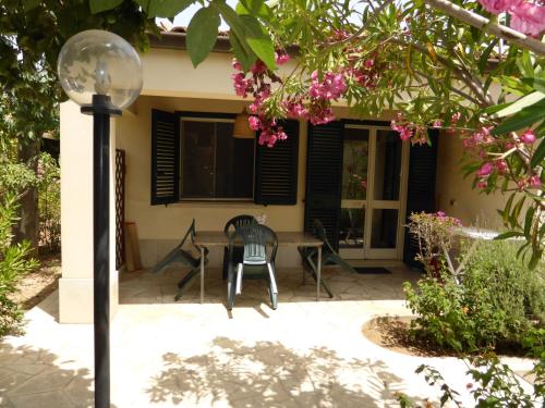 a patio with a table and chairs in front of a house at La Perla di Sicilia in Marina di Modica