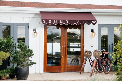 a bike parked outside of a store with a sign on the door at Sound View Greenport in Greenport