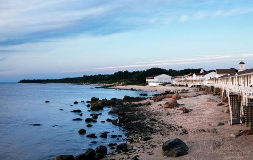 a beach with a row of houses and the water at Sound View Greenport in Greenport