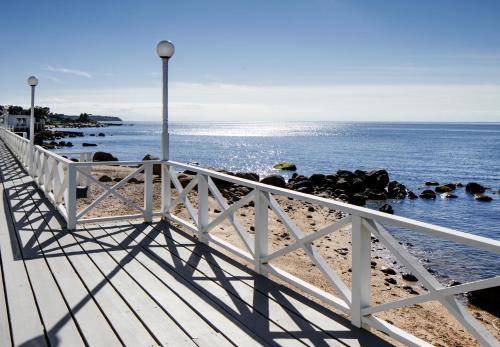 a white boardwalk on the beach with the ocean at Sound View Greenport in Greenport