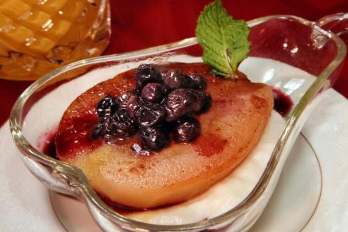 a dessert in a glass dish with blueberries on a plate at Barrister's Bed & Breakfast in Seneca Falls