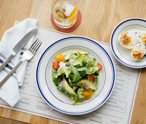 a plate of salad and eggs on a table at Sound View Greenport in Greenport