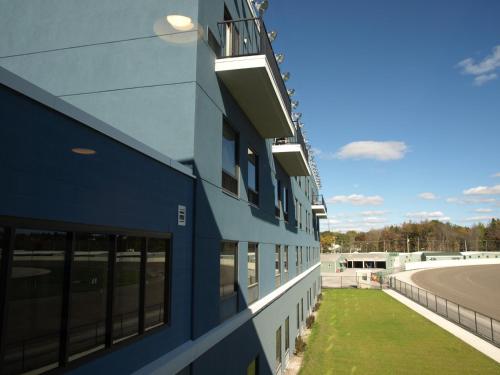a blue building with windows on the side of it at Hotel at Batavia Downs in Batavia