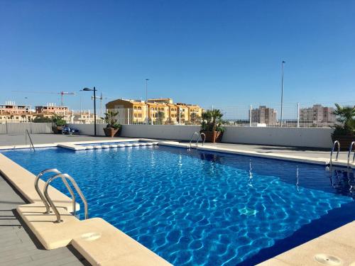 a swimming pool on the roof of a building at Altos del Mediterraneo La Zenia in Los Dolses
