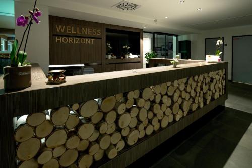 a lobby with a counter with wooden logs on it at PRIVILEGED LESNÁ - with Garden Terrace, Tatranská Lomnica 2 km in Tatranská Lomnica