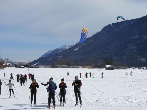a group of people on skis in the snow at TEMPFER 2 Apartments & Rooms with new WELLNESS in Kranjska Gora