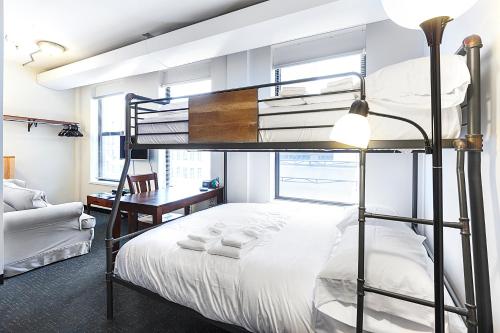 a bedroom with a bunk bed and a desk at Temple Place Suites in Boston