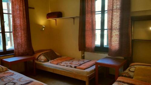 a bedroom with two beds and a window at Hostel Merlin in Český Krumlov