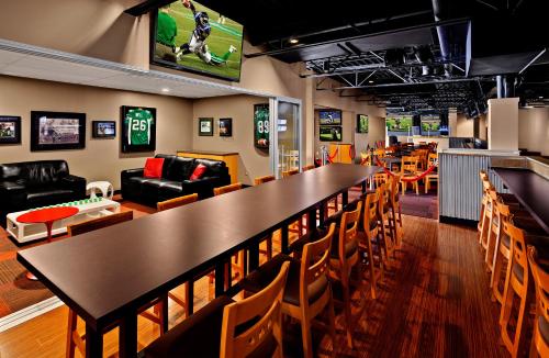 a dining room with a large table and chairs at Travelodge Hotel by Wyndham Saskatoon in Saskatoon