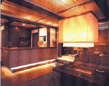 a living room with a couch and a lamp at Niigata Terminal Hotel in Niigata