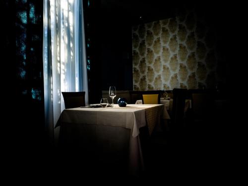 a table in a restaurant with a wine glass on it at Hotel Select in Atessa