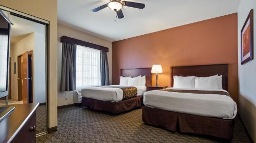 A bed or beds in a room at Best Western North Edge Inn