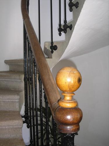 a wooden stair railing with a ball on top of it at La Saudade in Saint-Péray