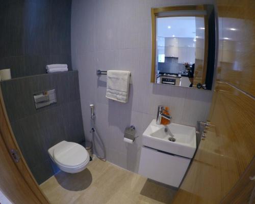 a bathroom with a toilet and a sink and a mirror at Hivernage Founty in Agadir