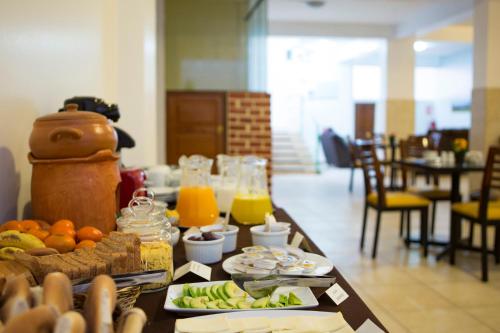 una mesa de desayuno con comida y bebidas. en Aqua hotel cusco, en Cusco