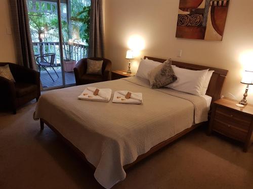 1 dormitorio con 1 cama con 2 toallas en Adamsons Riverside Accommodation, en Margaret River Town