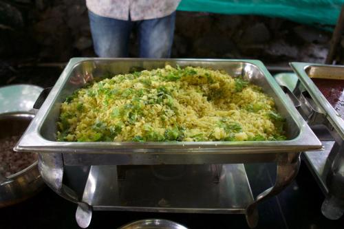 a metal pan filled with rice and broccoli at Avanti Kalagram Hill Top Resort, Mulshi in Kolvan