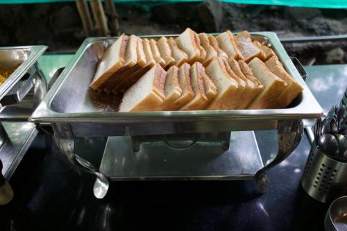 a tray full of sandwiches on a table at Avanti Kalagram Hill Top Resort, Mulshi in Kolvan