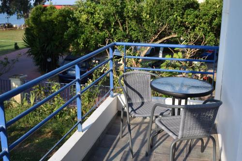 a balcony with two chairs and a table at Lydia Rooms & Studios in Preveza