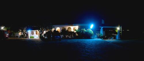 a building lit up at night with blue lights at Riviera Garden in Antananarivo