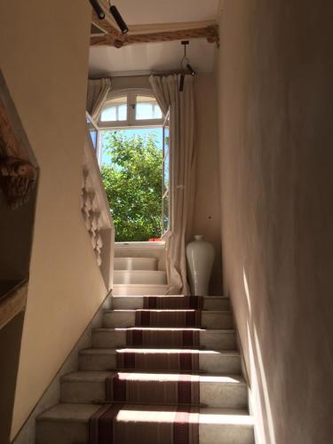 a staircase leading up to a window in a house at Hôtel Particulier Le 28 - Spa & Art Luxury Design by Alain Ducasse in Aix-en-Provence