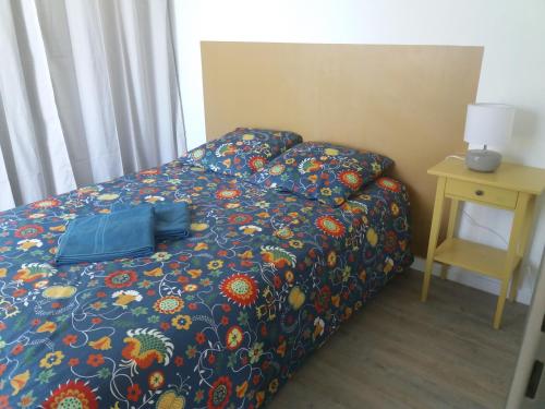a bed with a bag on it in a room at T3 le Ronsard in Montpellier