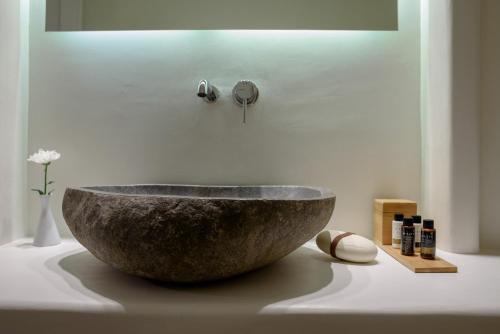 a stone bowl on a counter in a bathroom at Sea Dream Luxury Home in Fira