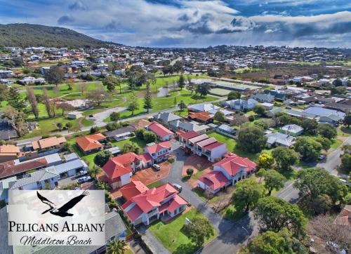 an aerial view of a town with houses and a bird at Pelicans Albany Middleton Beach in Albany