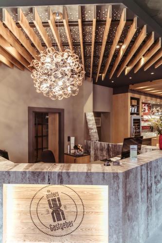 a bar with a chandelier in a restaurant at alexxanders Hotel & Boardinghouse, Restaurant in Chemnitz